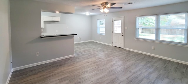 kitchen with white cabinets, ceiling fan, and dark hardwood / wood-style floors