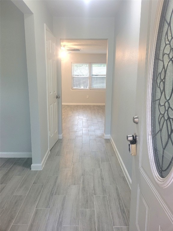 corridor with light wood-type flooring