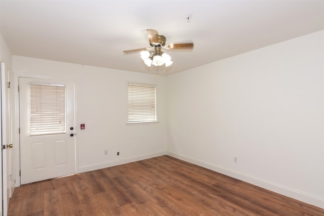 unfurnished room with ceiling fan and dark hardwood / wood-style floors