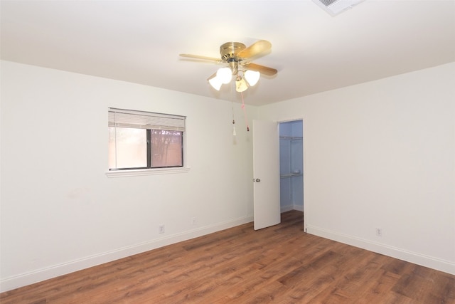 empty room featuring ceiling fan and dark wood-type flooring