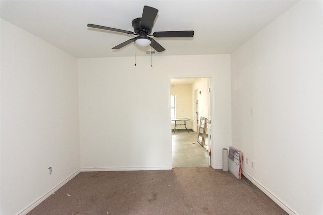 carpeted spare room featuring ceiling fan