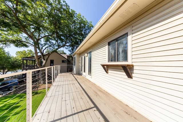 wooden terrace featuring a yard