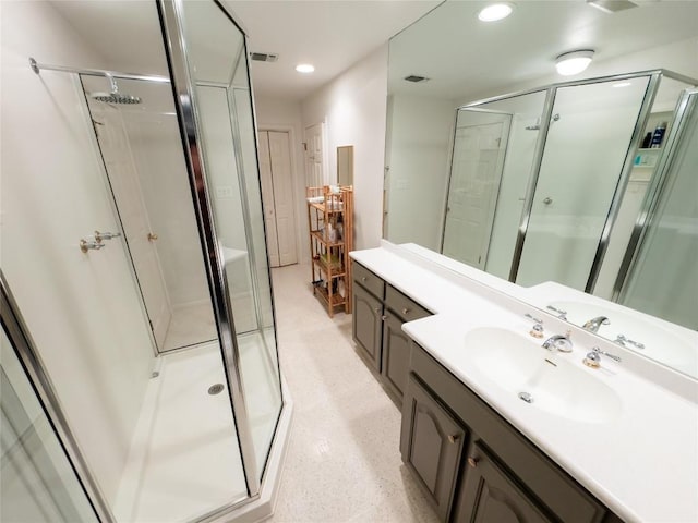 bathroom with vanity and a shower with shower door