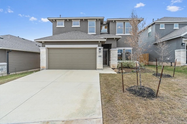 view of front of property featuring a garage and a front lawn