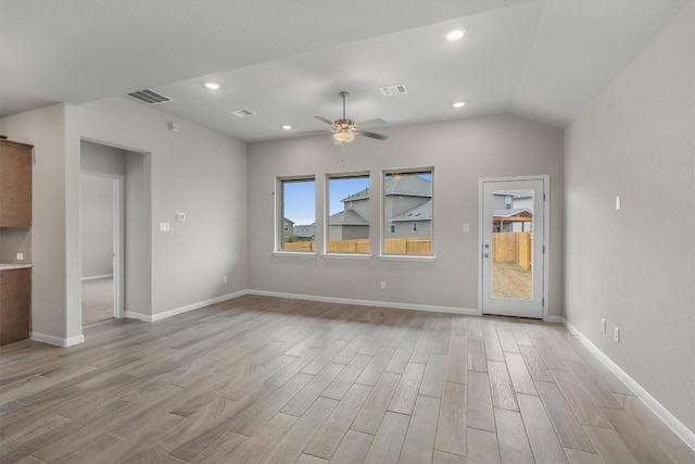 unfurnished living room featuring ceiling fan, vaulted ceiling, and light hardwood / wood-style floors