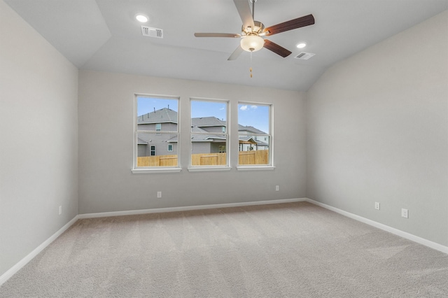 spare room featuring carpet floors, vaulted ceiling, and ceiling fan