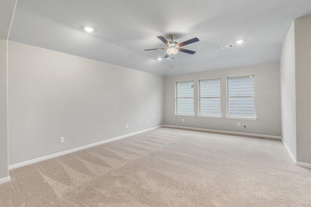 empty room featuring light carpet and ceiling fan