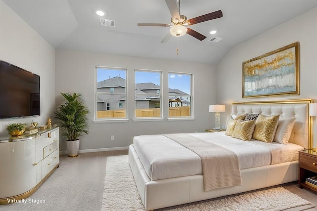 carpeted bedroom with ceiling fan and vaulted ceiling