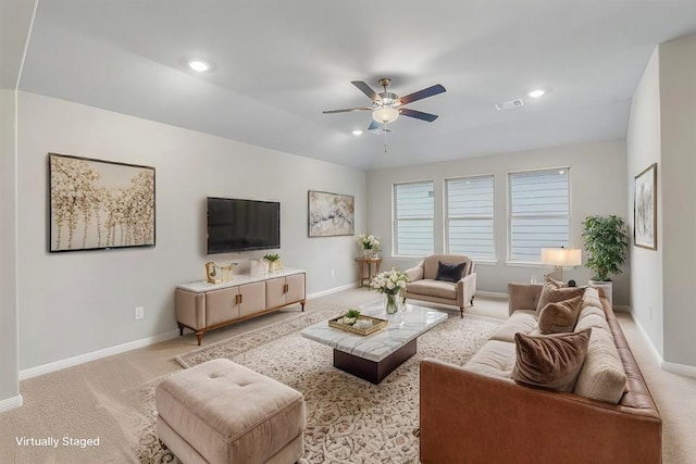 living room featuring light carpet and ceiling fan