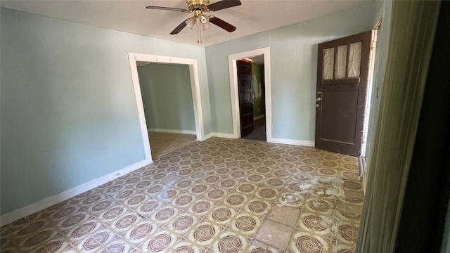 tiled spare room featuring ceiling fan