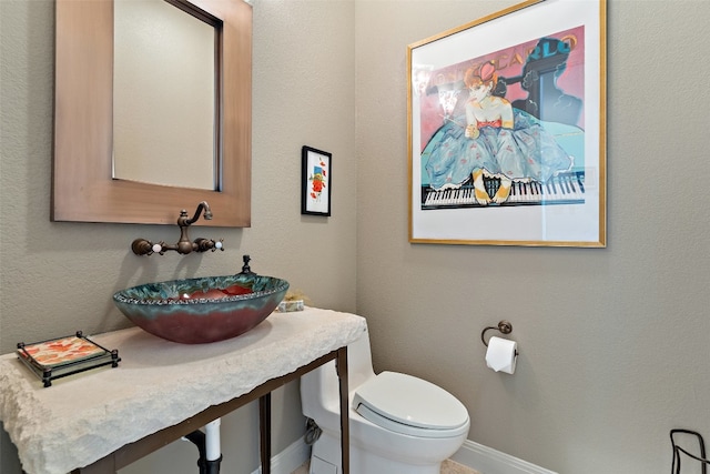 bathroom featuring sink and toilet