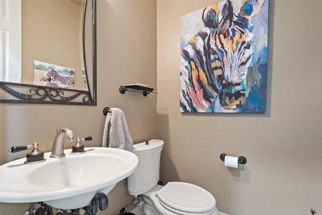 bathroom featuring sink and toilet