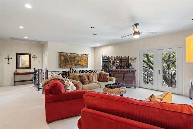 living room featuring light carpet, ceiling fan, and french doors