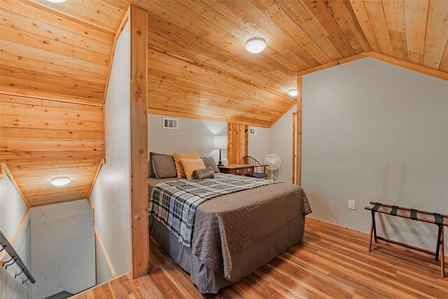 bedroom featuring hardwood / wood-style flooring, vaulted ceiling, and wooden ceiling