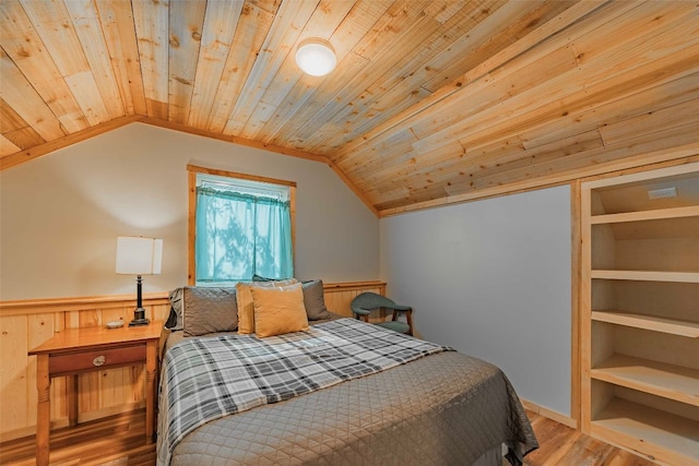 bedroom featuring vaulted ceiling, wood-type flooring, and wooden ceiling