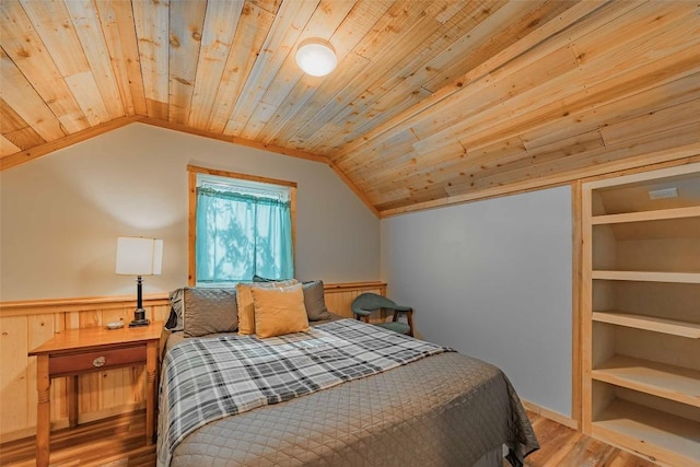 95 Loma Ln, Fredericksburg, TX 78624 - bedroom with wooden ceiling, lofted ceiling, wood finished floors, and a wainscoted wall