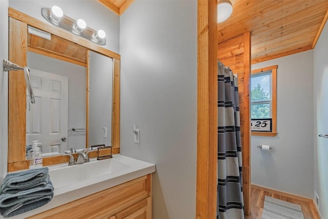 95 Loma Ln, Fredericksburg, TX 78624 - full bath with vanity, wood finished floors, curtained shower, wood ceiling, and baseboards