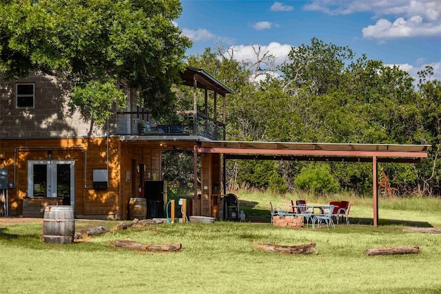 view of home's community with a fire pit and a yard