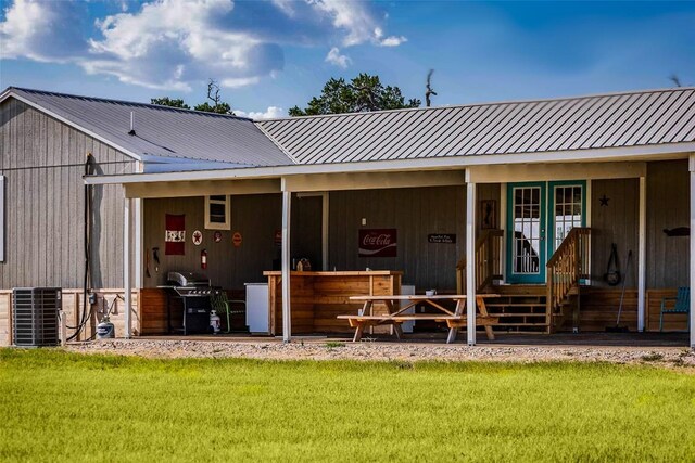 back of house featuring an outdoor structure and cooling unit