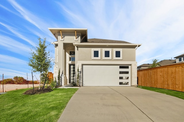 view of front facade featuring a garage and a front lawn