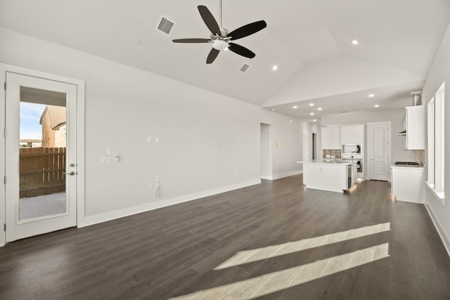 unfurnished living room featuring high vaulted ceiling, dark hardwood / wood-style flooring, and ceiling fan