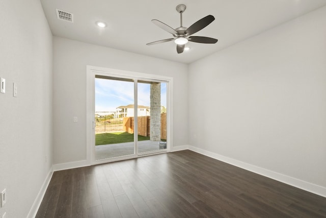 spare room with dark wood-type flooring and ceiling fan