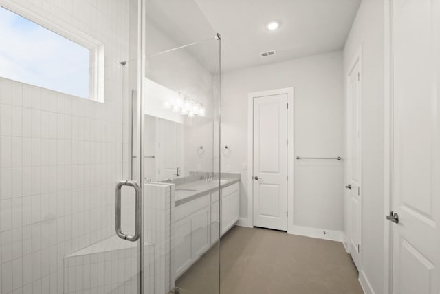 bathroom with an enclosed shower, tile patterned floors, and vanity