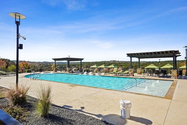 view of swimming pool with a patio area and a pergola