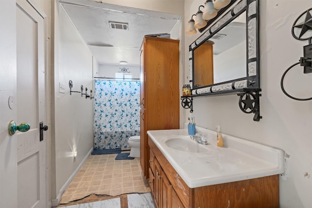 bathroom with tile flooring, oversized vanity, and toilet