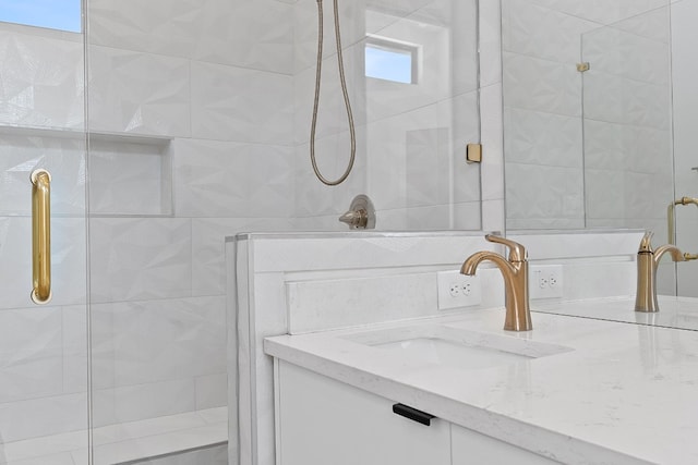 bathroom with an enclosed shower and vanity