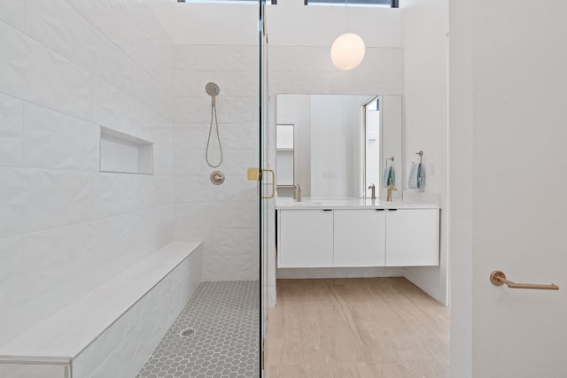 bathroom featuring vanity and a shower with shower door