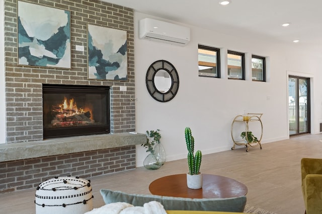 living room featuring a fireplace and a wall mounted AC