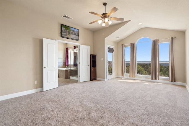 unfurnished bedroom featuring lofted ceiling, light colored carpet, and ceiling fan