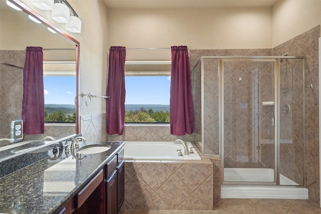 bathroom featuring plenty of natural light, plus walk in shower, tile floors, and vanity