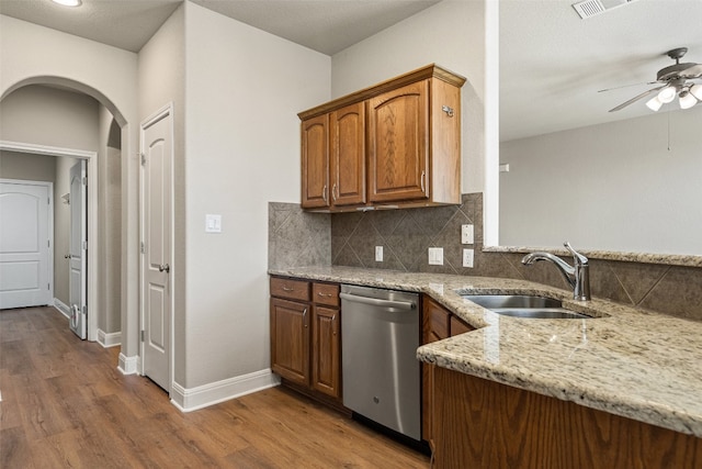 kitchen featuring hardwood / wood-style floors, sink, ceiling fan, and dishwasher