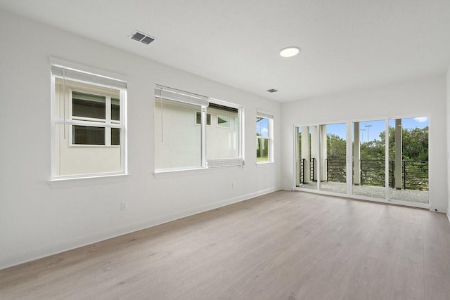 empty room with light hardwood / wood-style floors