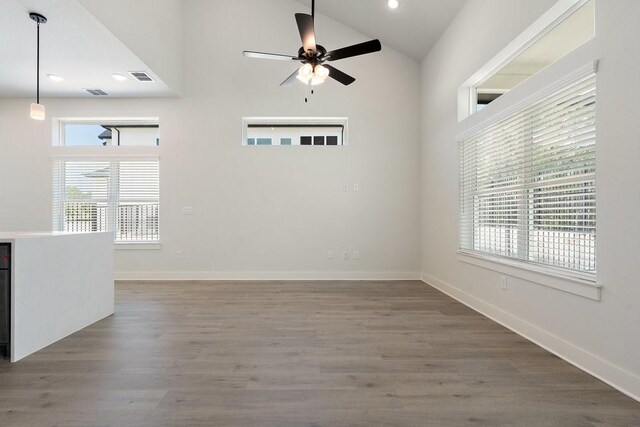 empty room featuring visible vents, wood finished floors, recessed lighting, baseboards, and ceiling fan