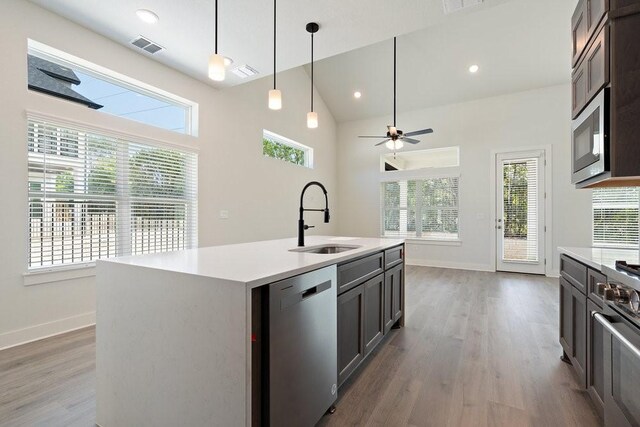 kitchen with a sink, visible vents, appliances with stainless steel finishes, and light countertops