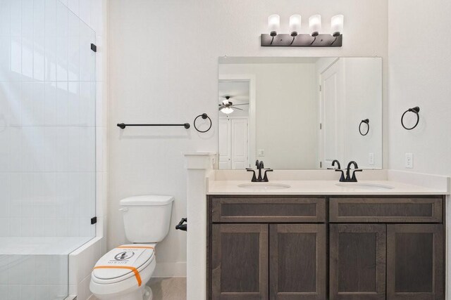 full bathroom featuring a sink, a shower, toilet, and double vanity