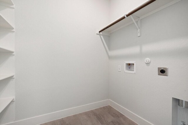 clothes washing area featuring electric dryer hookup, washer hookup, baseboards, gas dryer hookup, and laundry area