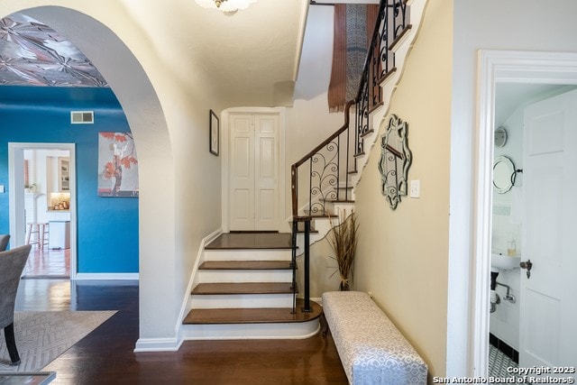 staircase featuring dark hardwood / wood-style floors