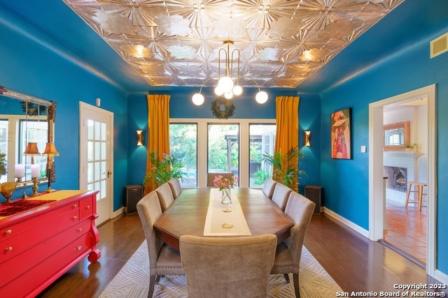 dining room featuring an inviting chandelier and dark hardwood / wood-style floors