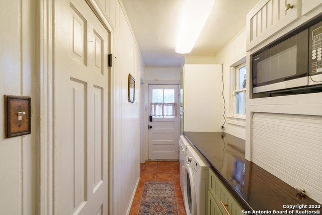 interior space featuring dark tile flooring and washer / dryer