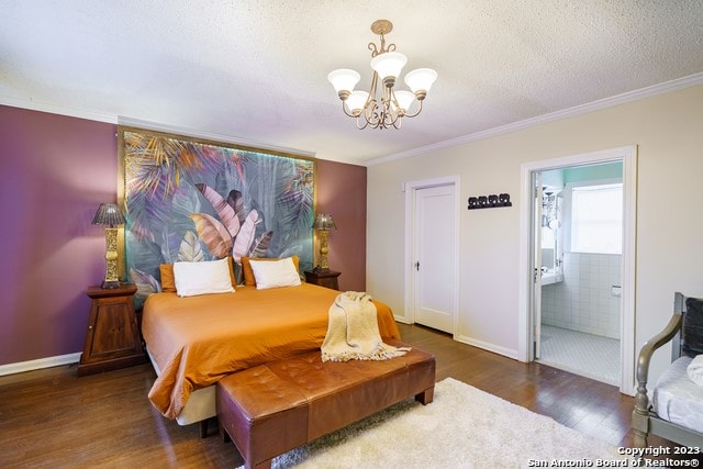 bedroom with dark wood-type flooring, connected bathroom, a textured ceiling, and a chandelier