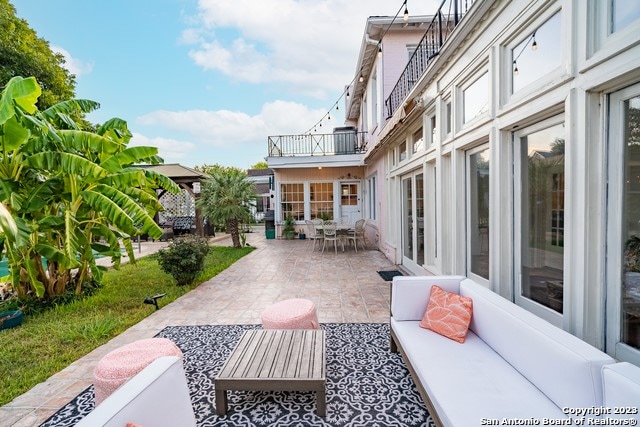 view of patio with a balcony and an outdoor hangout area