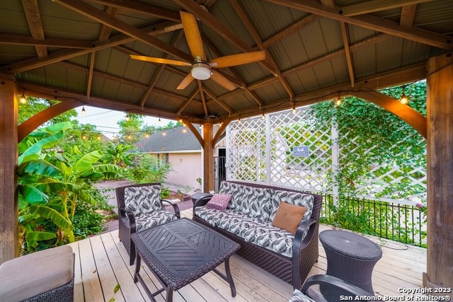 deck with a gazebo, outdoor lounge area, and ceiling fan