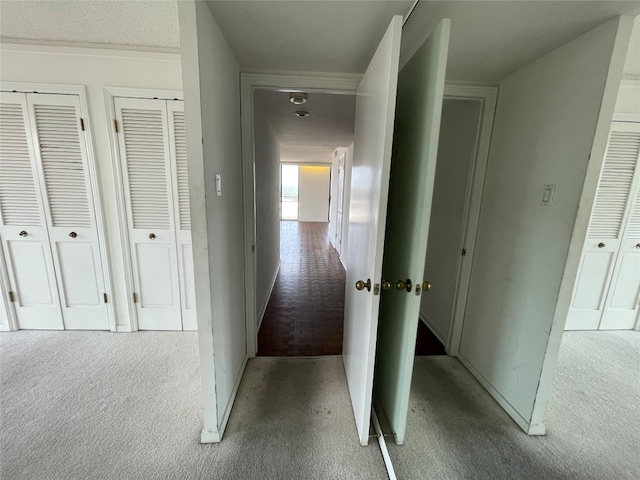 hallway with light colored carpet