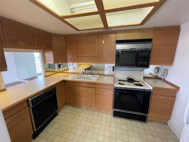 kitchen featuring sink, black appliances, and light tile floors