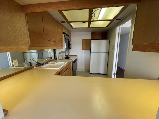 kitchen featuring light tile floors, kitchen peninsula, range with electric cooktop, and white fridge