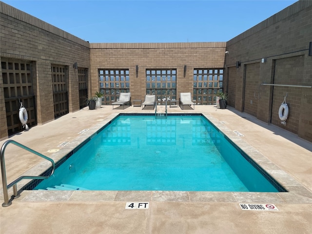 view of swimming pool featuring a patio